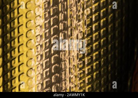 Select focus on abstract textured golden metal surface background Stock Photo