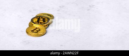 golden bitcoins on a concrete background, panoramic mock-up with space for text Stock Photo