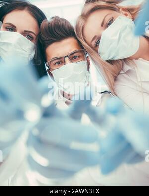 Team surgeons are performing an operation using medical instruments, in a modern operating room, Stock Photo