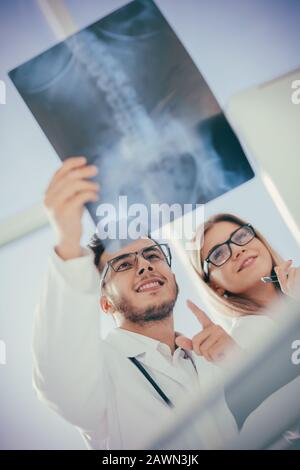 two orthopedic doctors looking at the x-ray of the patient Stock Photo