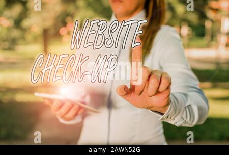 Text sign showing Website Check Up. Business photo text an examination of a website to see if something is in order Woman in a blue business shirts po Stock Photo