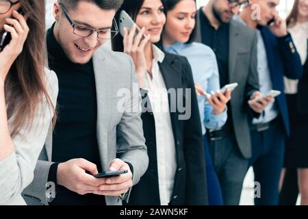 group of diverse young people use their smartphones Stock Photo