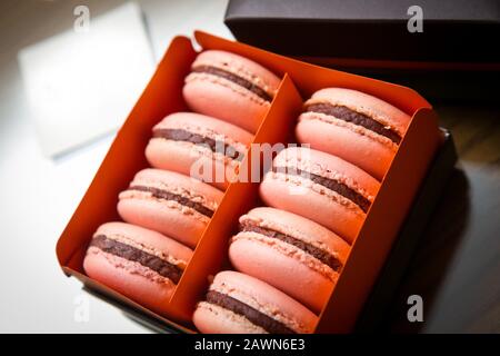 Tasty macaroons in carton box on table Stock Photo