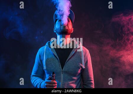 Vaping flavored e-liquid from an electronic cigarette Stock Photo