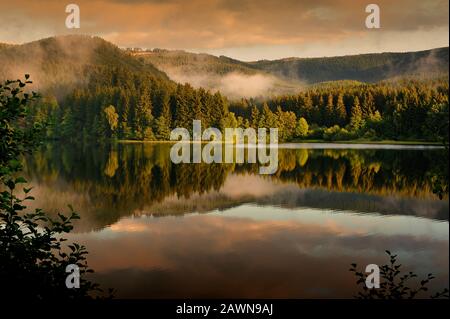 Lake surrounded by mountains,Harz,Germany. Stock Photo