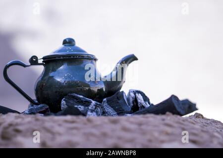 https://l450v.alamy.com/450v/2awnbp8/ancient-metal-teapot-on-burning-coals-with-a-blurred-background-2awnbp8.jpg