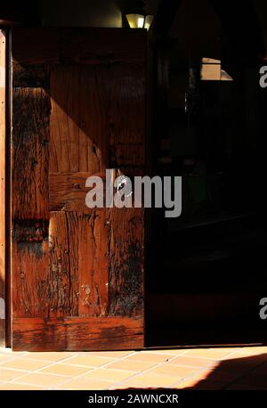 Vertical shot of a wooden door covered in a shadow Stock Photo