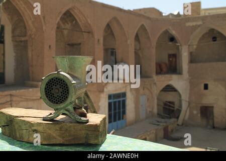 Wide angle shot of a metal grinder in front of a building Stock Photo