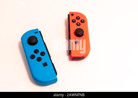 A pair of Nintendo Joy-Con controllers on solid white, the most often criticized component of the otherwise successful Nintendo Switch video game syst Stock Photo