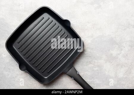 Cast Iron Grill Pan On Grey Concrete Background. Cooking BBQ Grill Concept. Top View Copy Space Stock Photo