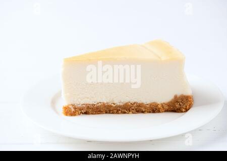 Classical Plain Cheesecake Slice On White Plate Isolated On White Background Stock Photo