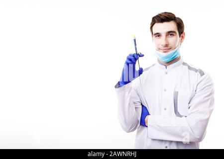 Handsome Young Physician in White Scrubs Posing With a Syringe Stock Photo