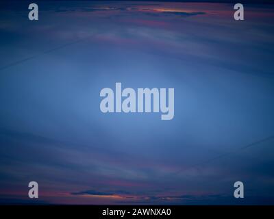 A Swirling Abraction of Clouds At Sunrise Stock Photo