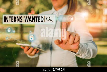 Writing note showing Interns Wanted. Business concept for temporary position with an emphasis on the job training Stock Photo