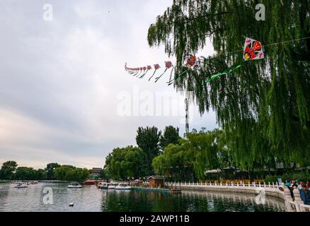 Long Chinese kite flying over Houhai Imperial Lake, Xi Cheng Hutong District, Beijing, China, Asian Stock Photo