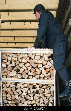 customs officers inspect a truck with lumber. officer inspects while standing on pallets Stock Photo