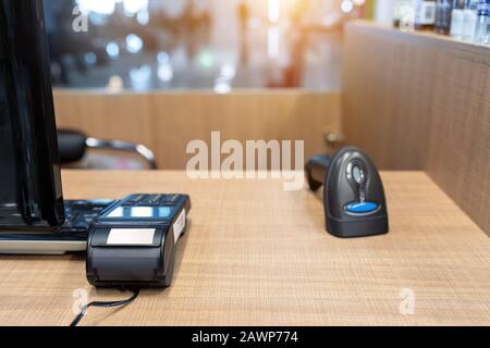 Emty cashier desk counter POS terminal with barcode scanner, receipt printer, wallet and credit card reader equipment. Payment trade through mobile Stock Photo