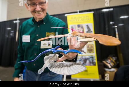 Toronto, Canada. 9th Feb, 2020. Woodcarver Ken Maitland poses for photos with his carved wooden balancing birds during the 2020 Toronto Woodworking Show in Toronto, Canada, on Feb. 9, 2020. As one of the newest consumer woodworking shows in Canada, this annual event celebrated everything to do with wood for hobbyist and professionals from Friday to Sunday. Credit: Zou Zheng/Xinhua/Alamy Live News Stock Photo