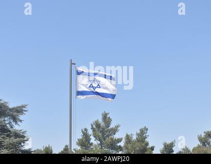 Israeli flag waving in Mount Herzl Cemetery in Jerusalem Stock Photo