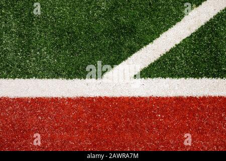 White lines on green and red artificial turf. Stock Photo