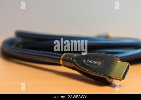 Closeup shot of an HDMI cable on a wooden surface Stock Photo