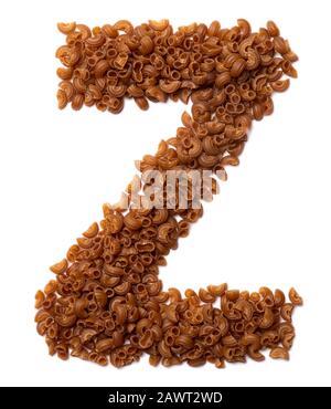 Letter Z of the English alphabet from dry pasta from buckwheat amaranth flour   on a white isolated background. Food pattern made from macaroni tubes. Stock Photo