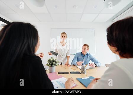 Cheerful business team working on new creative project together Stock Photo