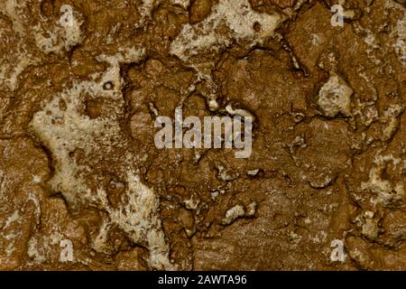 A close-up of an uneven stone wall texture background Stock Photo