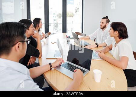 Business partners meeting in office to discuss results of teamwork Stock Photo
