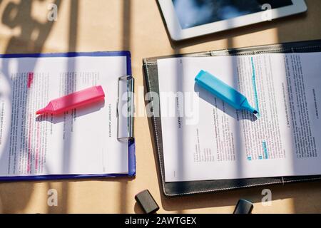 Two copies with partnership agreement with pink and blue highlighters, view from above Stock Photo