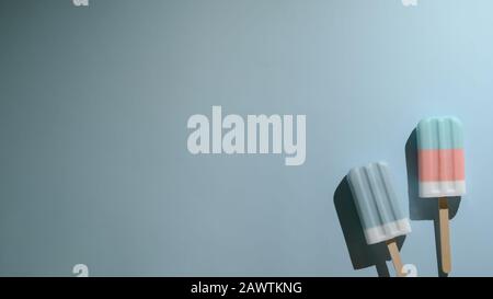 Top view of pastel popsicles and copy space, summer minimal concept on light blue background Stock Photo