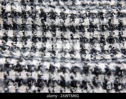 Full frame knitted warm black and white scarf as a backdrop.  Stock Photo