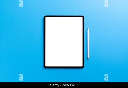 digital tablet and stylus pen on light blue background Stock Photo