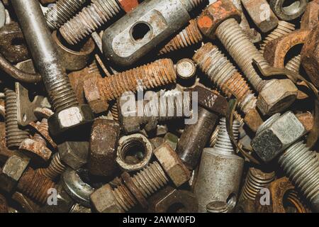 Rusty bolts and nuts of different sizes. scrap metal. industrial background Stock Photo