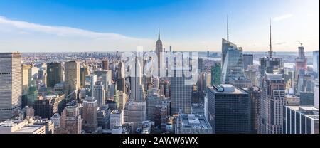 Panoramic photo of New York City Skyline in Manhattan downtown with Empire State Building and skyscrapers on sunny day with clear blue sky USA Stock Photo