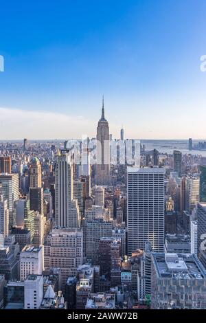 New York City Skyline in Manhattan downtown with Empire State Building and skyscrapers on sunny day with clear blue sky USA Stock Photo
