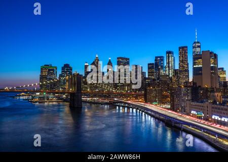 Brooklyn Bridge in Manhattan downtown with Cityscape at night New York USA