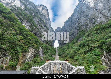 The Heaven's Gate of Tianmen Mountain National Park with 999 step stairway on a cloudy day with blue sky, Zhangjiajie, Changsha, Hunan, China Stock Photo