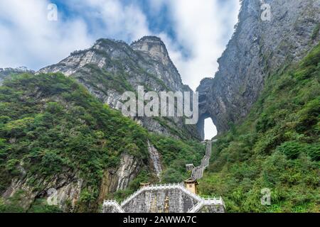 The Heaven's Gate of Tianmen Mountain National Park with 999 step stairway on a cloudy day with blue sky, Zhangjiajie, Changsha, Hunan, China Stock Photo