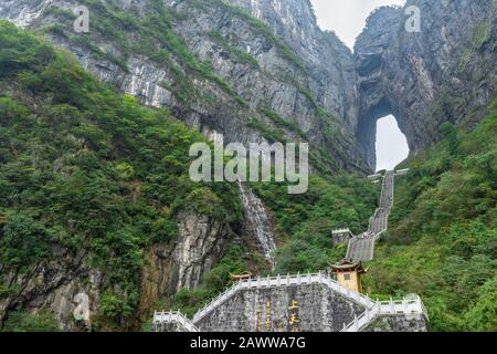 The Heaven's Gate of Tianmen Mountain National Park with 999 step stairway on a cloudy day with blue sky, Zhangjiajie, Changsha, Hunan, China Stock Photo