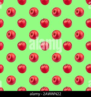 Seamless pattern of fresh red apples on green background isolated, bright shiny apple repeating ornament, tasty juicy ripe fruits backdrop, wallpaper Stock Photo