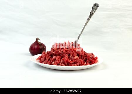 Carnivore diet. Raw ground beef lies on a plate. Minced meat. Conception carnivor. Stock Photo