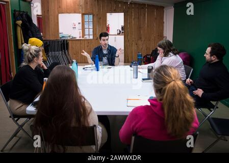 Actors in a rehearsal room listening to a director talking about the research and development of new theatre work. Stock Photo