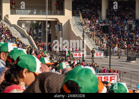 Amritsar, India - Febuary 8, 2020: Indian women prepare to dance in the parade as the Indian Border Security Force hypes up the crowd for the Wagah Bo Stock Photo