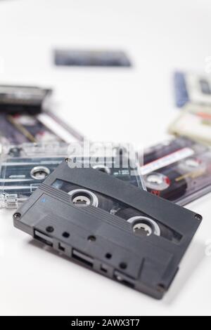 Pile of compact audio music cassette tapes on a white background Stock Photo