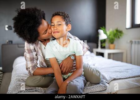 Mother playing bonding hugging with her son. Happy family time. Stock Photo