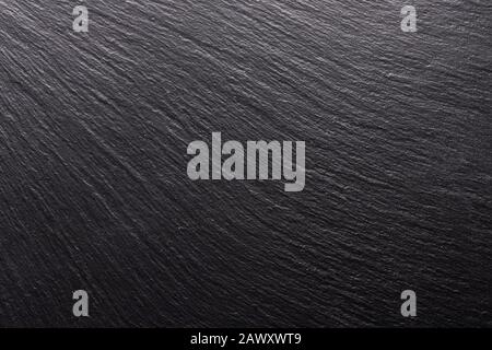 black stone, texture for the background. smooth shadows and light on the structural surface. Stock Photo