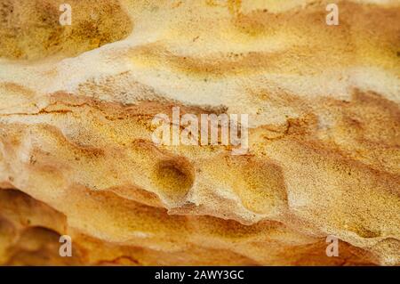 Rough yellow grainy natural sand stone texture background free form line and scratches Stock Photo