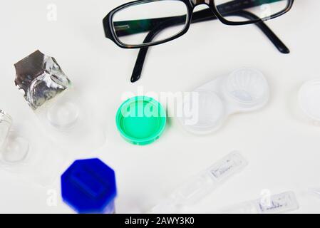 Contact lens case in a flat lay pattern with other eye care products including glasses, drops, and other cases Stock Photo