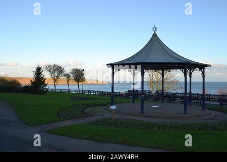 Filey - Cresent Gardens and Bandstand on a Sunny Day Looking Towards Filey Brigg - North Yorkshire UK Stock Photo